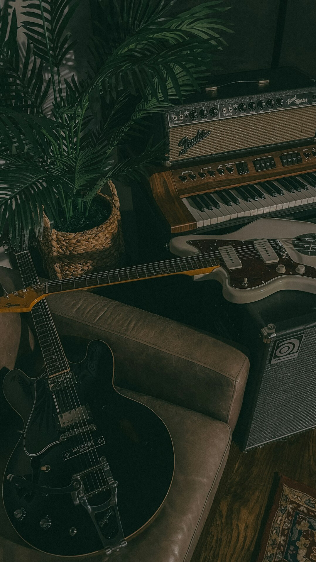 Vintage home recording studio with mixing console and guitars