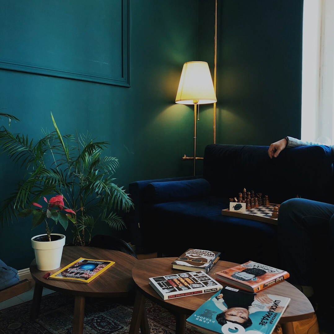 Retro 1980s living room with velvet sofa and brass lamps