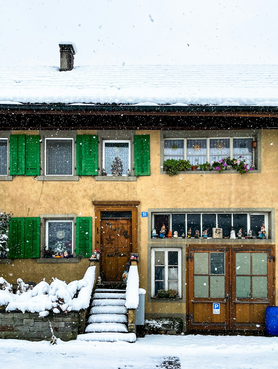 Swiss alpine chalet with wooden balconies covered in snow